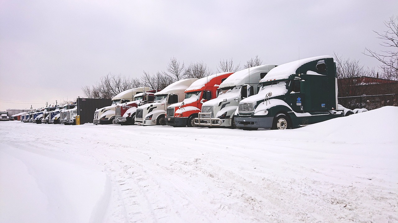 trucks in snow, snow truck, truck yard
